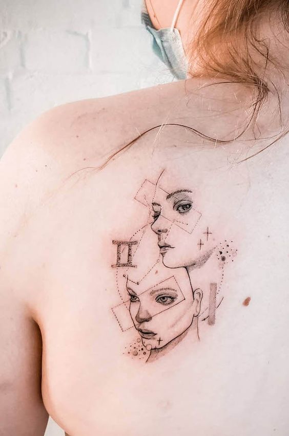 Tatouage Signe Gémeaux Avec Visages Et Figures Géométriques Sur L'omoplate 