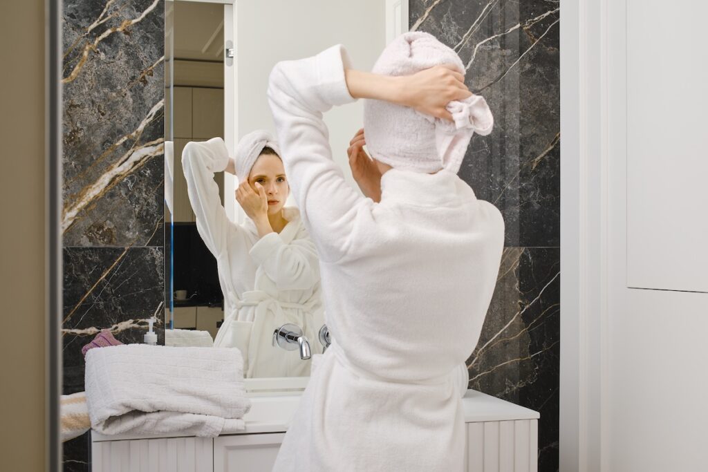 Woman In Bathrobe In Front Of A Mirror 2024 03 21 03 55 10 Utc