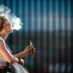 Young Woman Outdoor Vaping E Cigarette On Modern C 2024 10 30 22 50 52 Utc