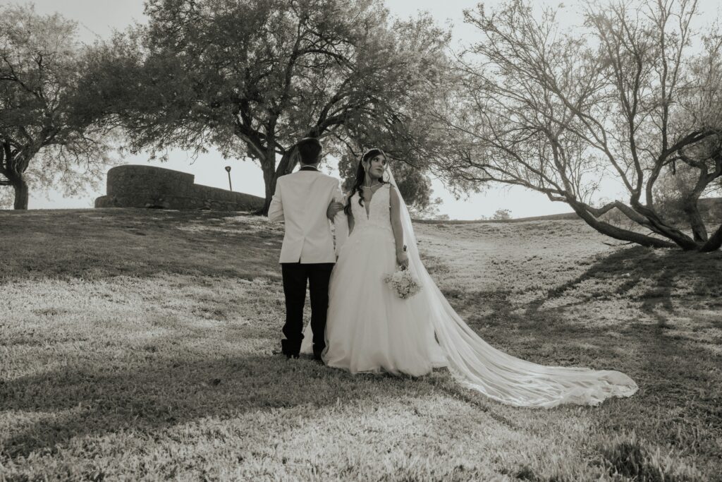 Bride And Groom Walking Away In A Park